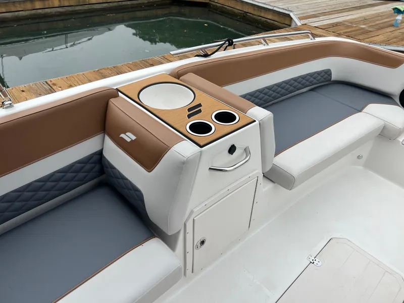 Slide: The Image of 2025 Starcraft SVX 211 OB boat interior with seating and cup holders. - 12