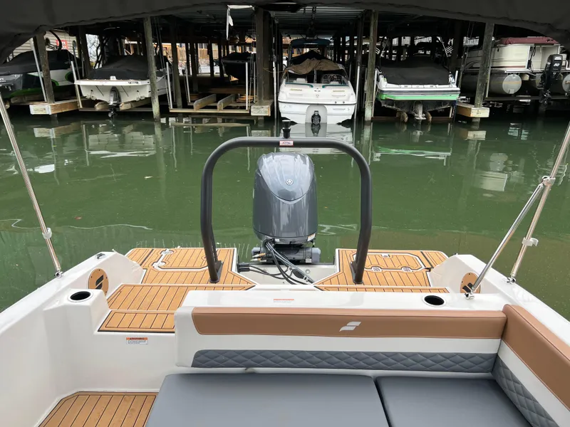 Slide: The Image of 2025 Starcraft SVX 211 OB boat docked, featuring modern design and outboard motor. - 15