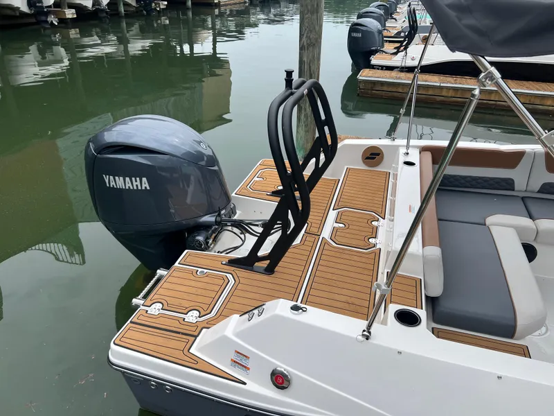 Slide: The Image of 2025 Starcraft SVX 211 OB boat with Yamaha outboard motor, docked on calm water. - 4