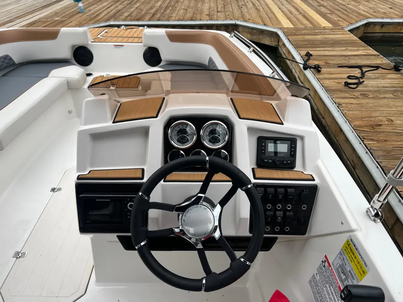 Slide: The Image of 2025 Starcraft SVX 211 OB boat dashboard with steering wheel and control panel. - 5
