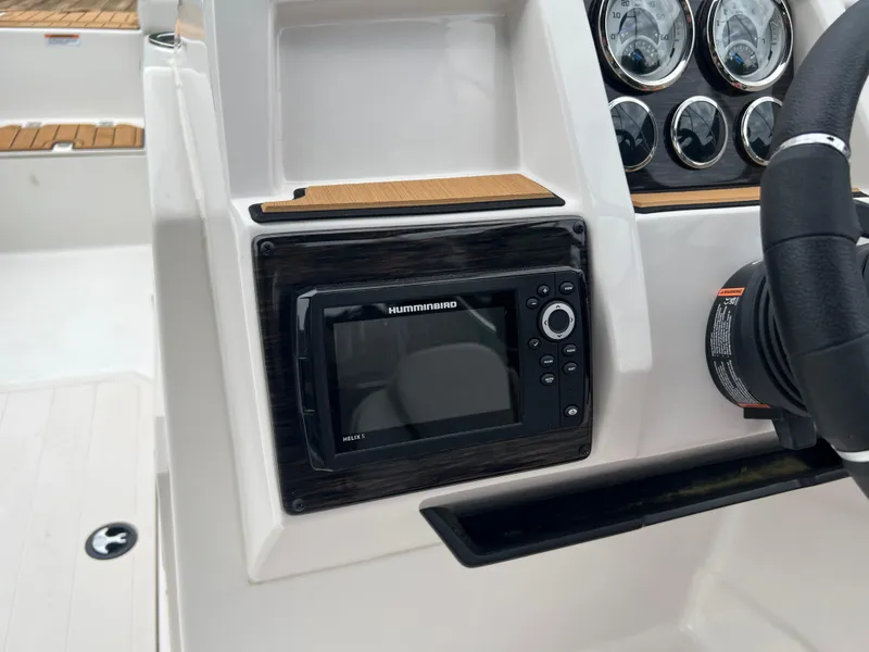 Slide: The Image of 2025 Starcraft SVX 211 OB boat dashboard with Humminbird electronics and gauges. - 6