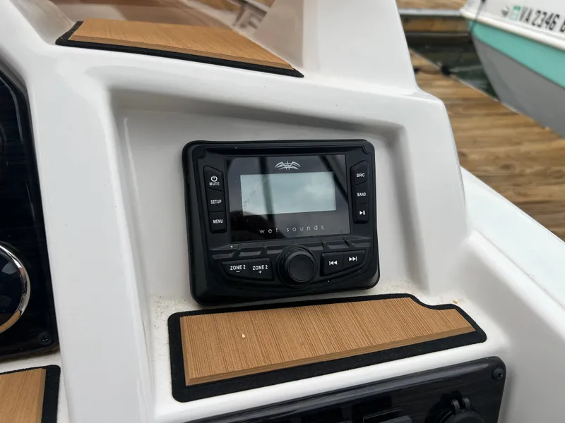 Slide: The Image of 2025 Starcraft SVX 211 OB boat dashboard with audio system. - 7