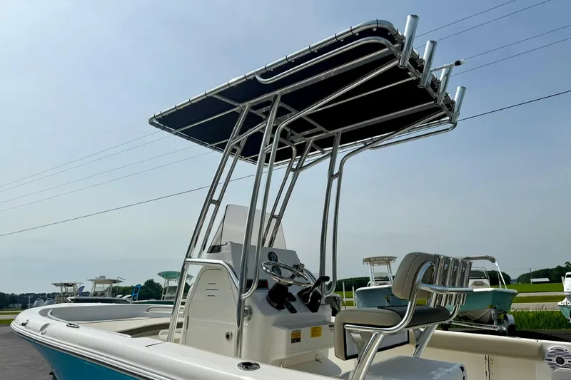 Slide: The Image of 2025 Key West 189 FS boat with T-top and console, docked outdoors. - 10