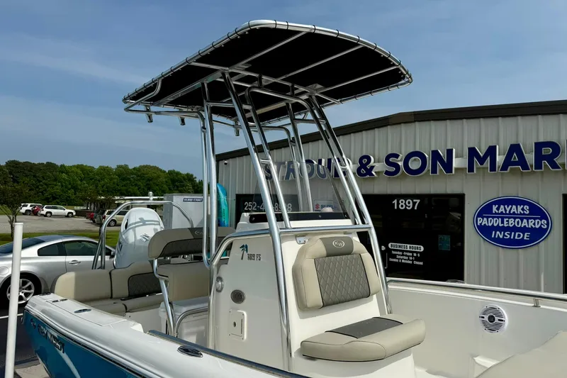 Slide: The Image of 2025 Key West 189 FS boat with T-top, parked outside a marine store. - 11