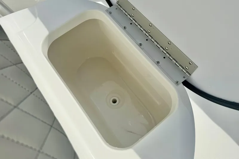Slide: The Image of Open storage compartment on 2025 Key West 189 FS boat, featuring a clean, white interior. - 18