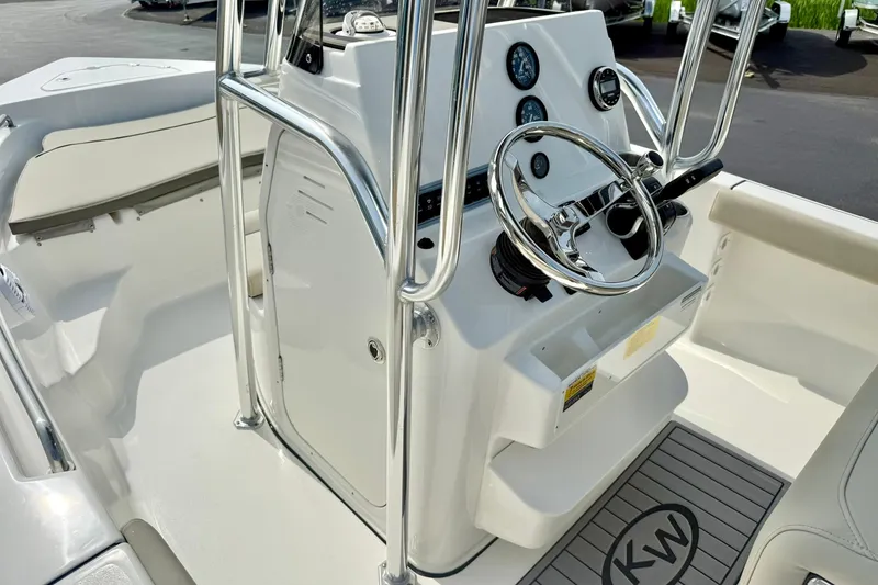 Slide: The Image of 2025 Key West 189 FS boat console with steering wheel and gauges, featuring sleek design. - 22