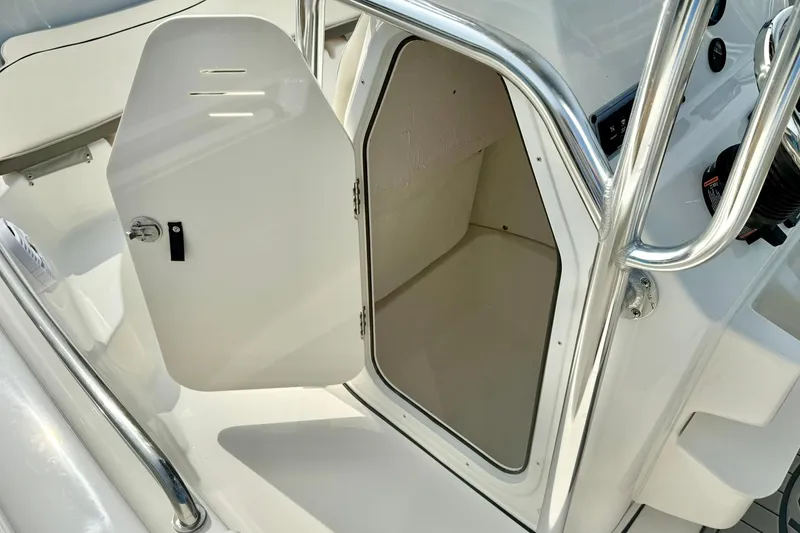 Slide: The Image of 2025 Key West 189 FS boat storage compartment with open door, showcasing interior space. - 23