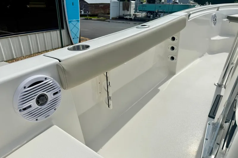 Slide: The Image of 2025 Key West 189 FS boat interior with cushioned seating and built-in speakers. - 33