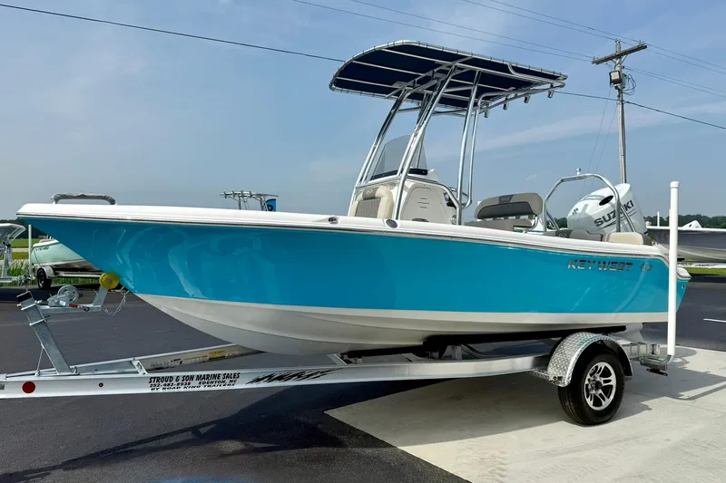 Slide: The Image of 2025 Key West 189 FS boat on trailer, featuring a vibrant blue hull and T-top. - 5
