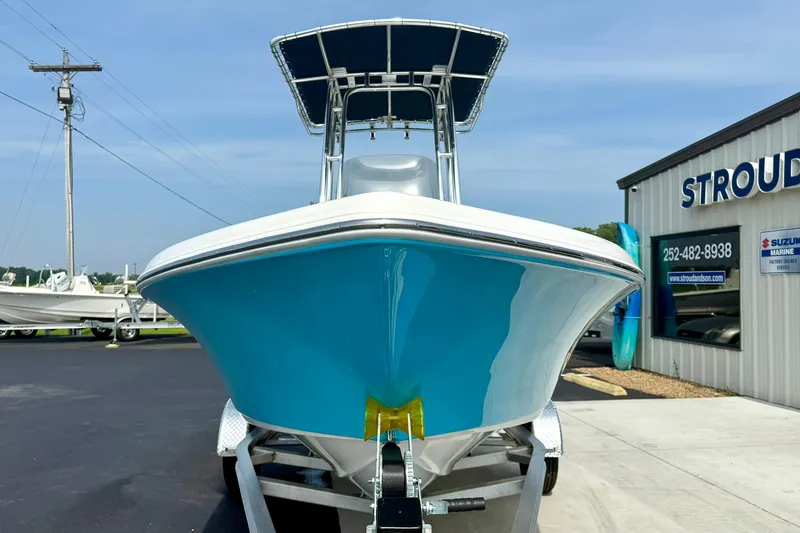 Slide: The Image of 2025 Key West 189 FS boat, blue hull, parked outside dealership. - 7