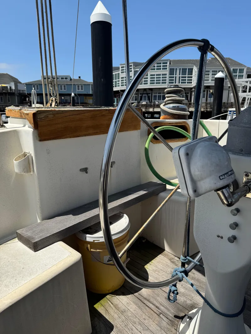 Slide: The Image of Cockpit of 1980 Cooper Marine Mapleleaf 48 sailboat with steering wheel and dock view. - 10