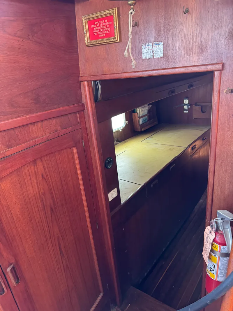 Slide: The Image of Interior of 1980 Cooper Marine Mapleleaf 48 yacht with wooden cabinetry and fire extinguisher. - 11