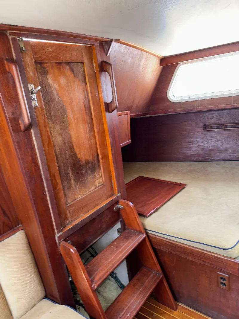Slide: The Image of Interior of 1980 Cooper Marine Mapleleaf 48 with wooden cabinetry and cozy sleeping area. - 14