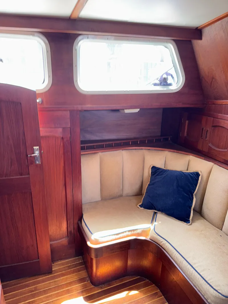 Slide: The Image of Cozy interior of 1980 Cooper Marine Mapleleaf 48 yacht with wooden finish and cushioned seating. - 15