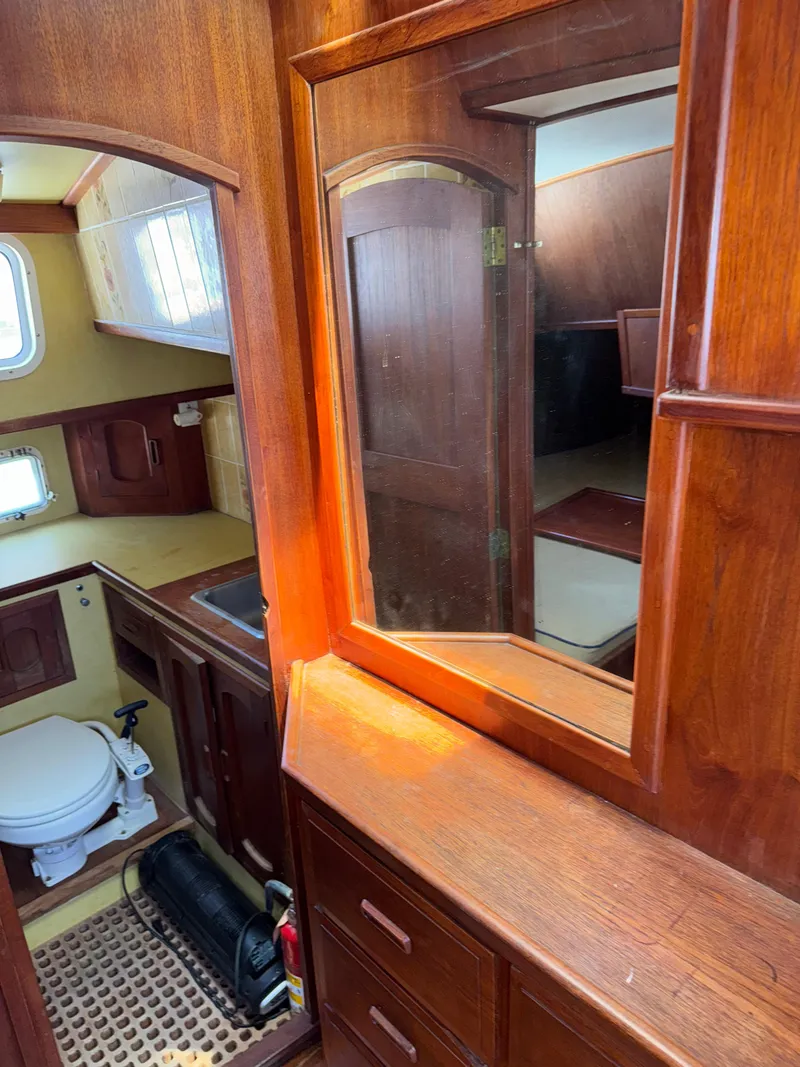 Slide: The Image of Interior of 1980 Cooper Marine Mapleleaf 48 yacht with wooden cabinetry and bathroom. - 18