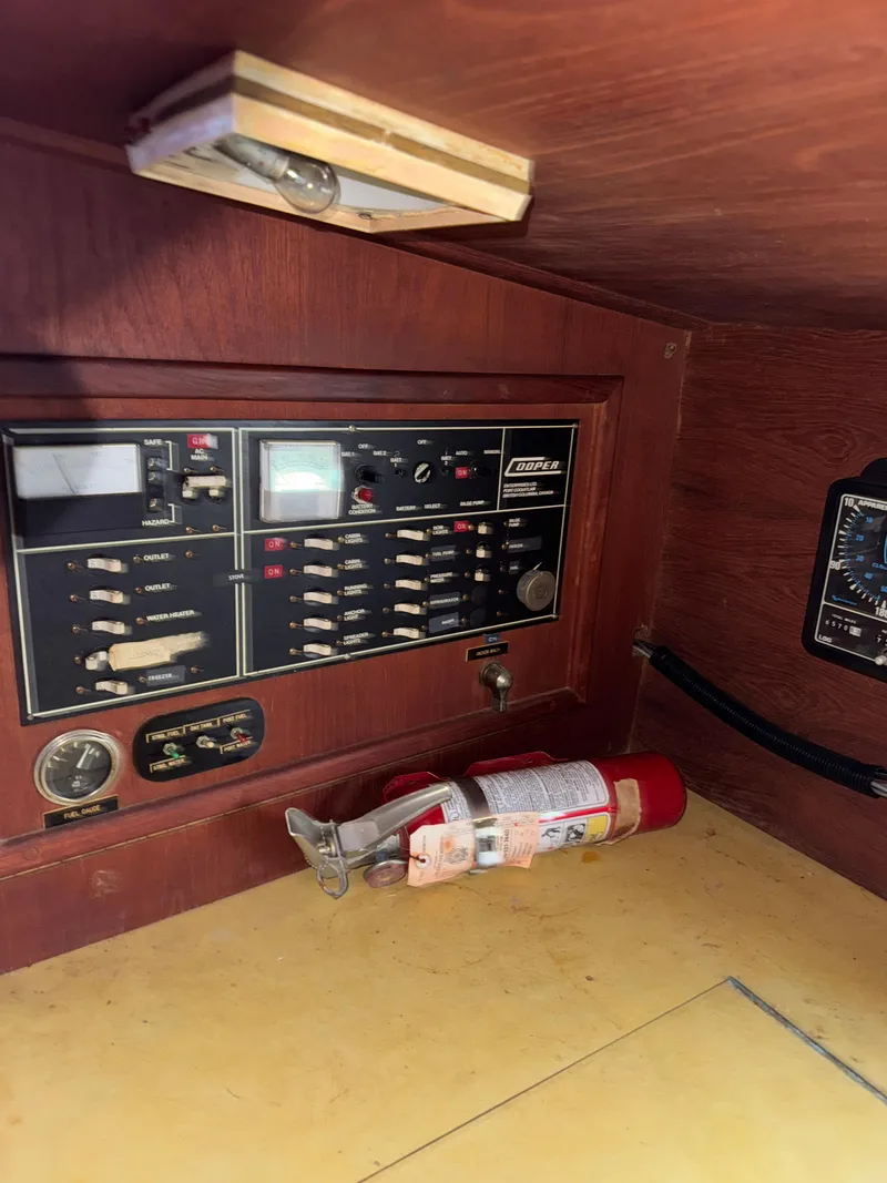 Slide: The Image of Control panel and fire extinguisher inside 1980 Cooper Marine Mapleleaf 48 boat. - 20