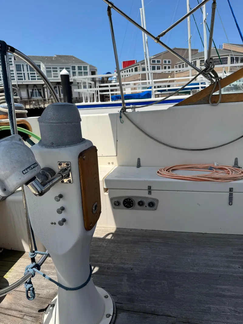 Slide: The Image of Cockpit of 1980 Cooper Marine Mapleleaf 48 sailboat with steering pedestal and marina view. - 9