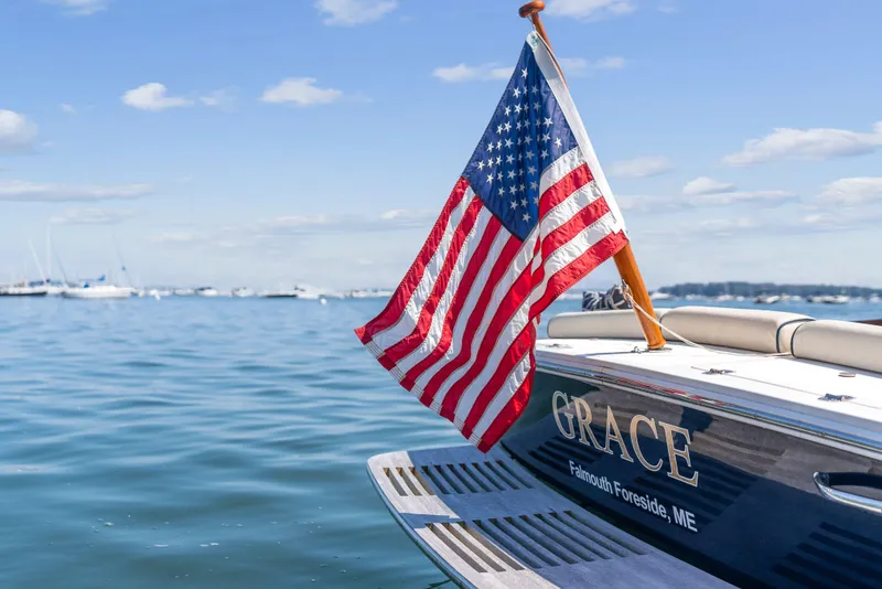Slide: The Image of American flag on 2015 Hunt Yachts 25 Harrier, Falmouth Foreside, ME, on calm water. - 15