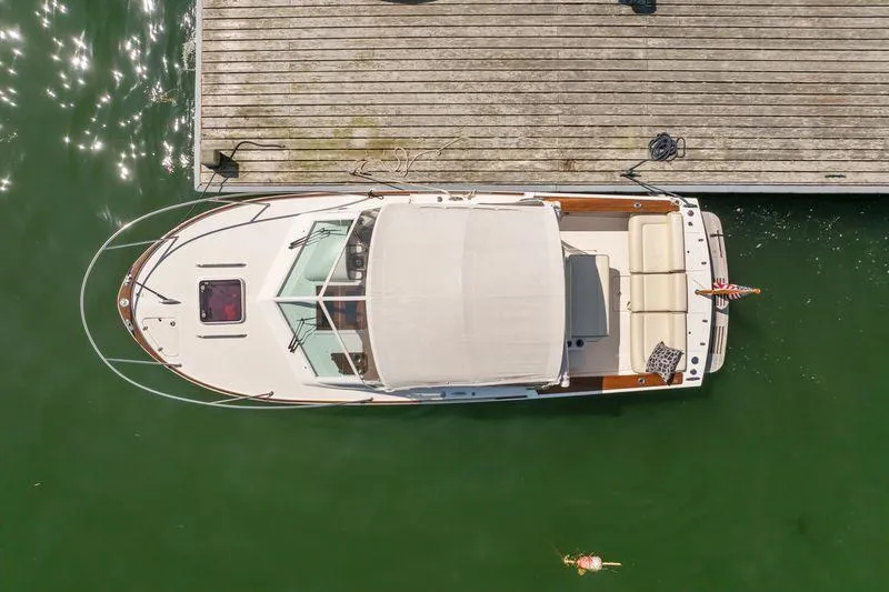 Slide: The Image of Overhead view of 2015 Hunt Yachts 25 Harrier docked on calm green water. - 19