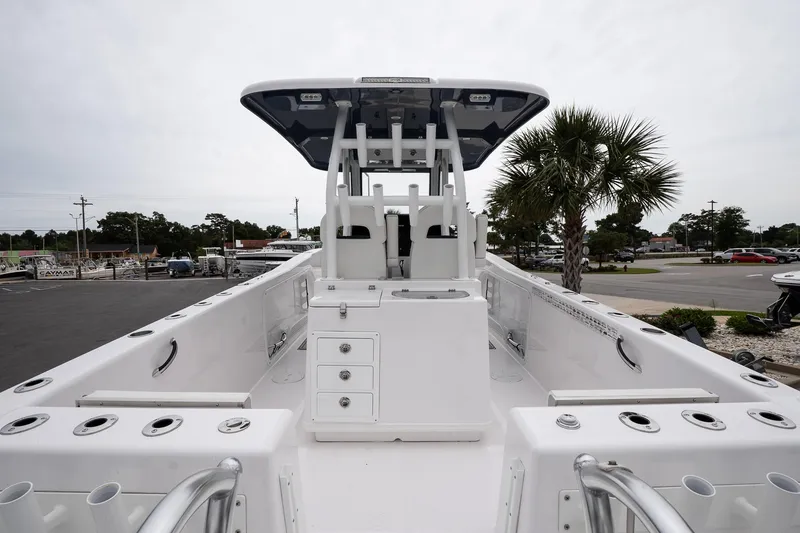 Slide: The Image of 2025 Twin Vee 260 GFX2 CC boat, center console, sleek design, spacious deck, palm tree background. - 11