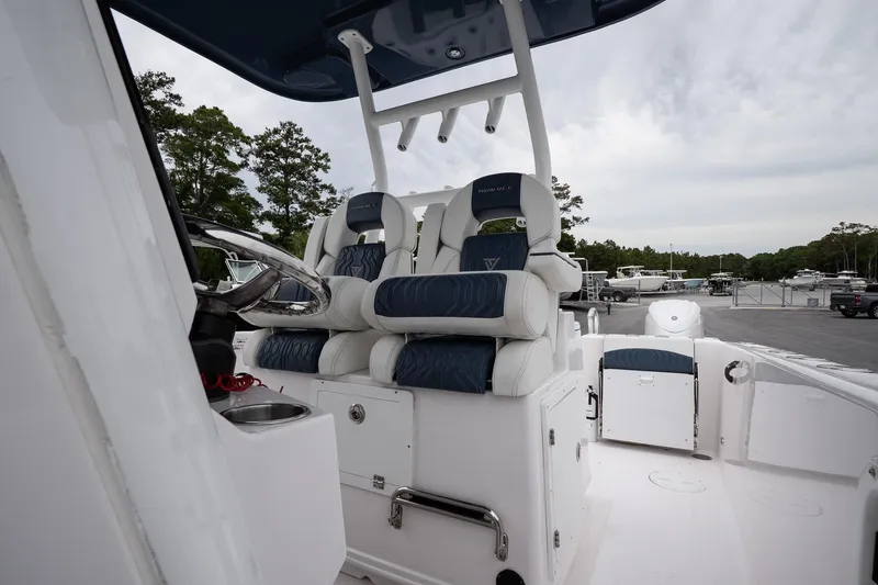 Slide: The Image of 2025 Twin Vee 260 GFX2 CC boat interior with dual cushioned seats and steering console. - 14