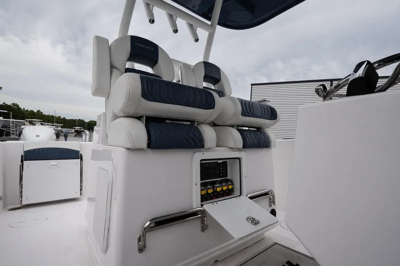 Slide: The Image of 2025 Twin Vee 260 GFX2 CC boat interior with cushioned seating and control panel. - 16