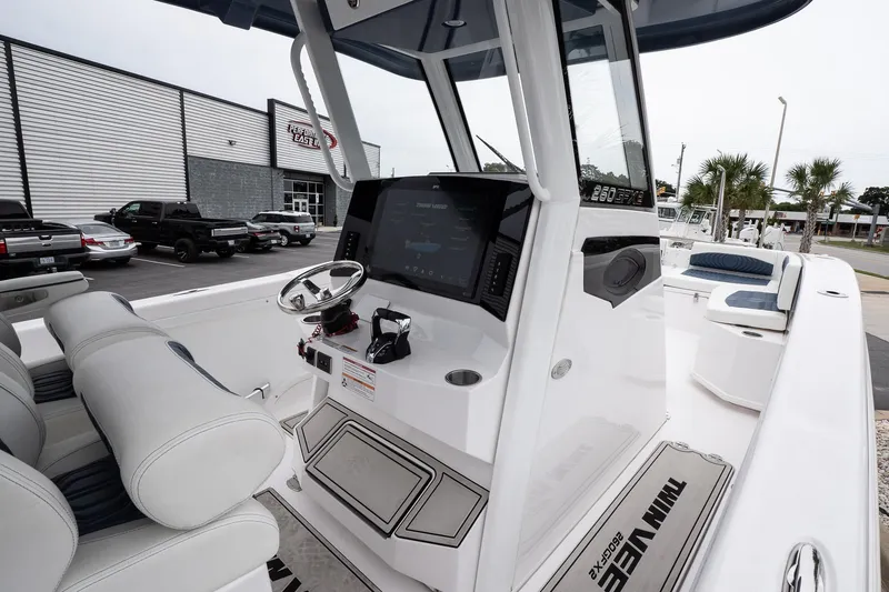 Slide: The Image of 2025 Twin Vee 260 GFX2 CC boat interior with modern console and seating. - 18