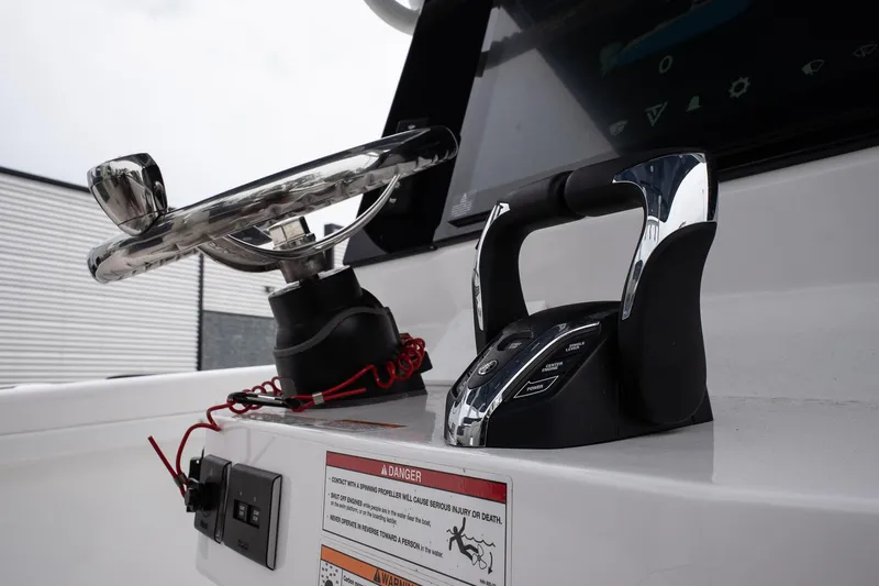 Slide: The Image of 2025 Twin Vee 260 GFX2 CC boat dashboard with steering wheel and controls. - 20