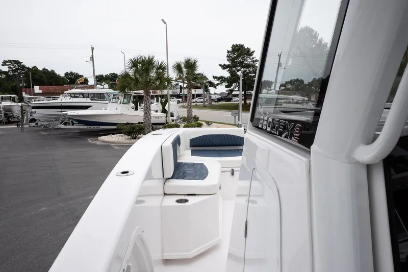 Slide: The Image of 2025 Twin Vee 260 GFX2 CC boat with seating, docked in a marina. - 21