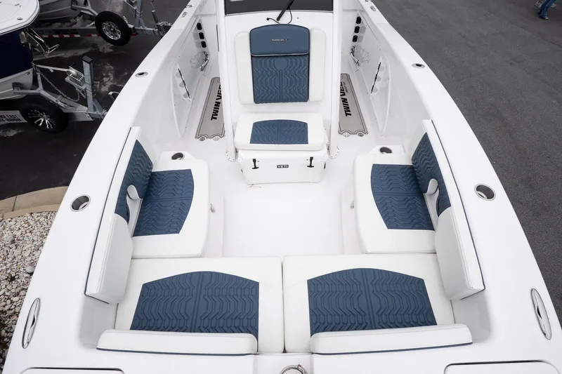 Slide: The Image of 2025 Twin Vee 260 GFX2 CC boat interior with blue and white seating. - 24