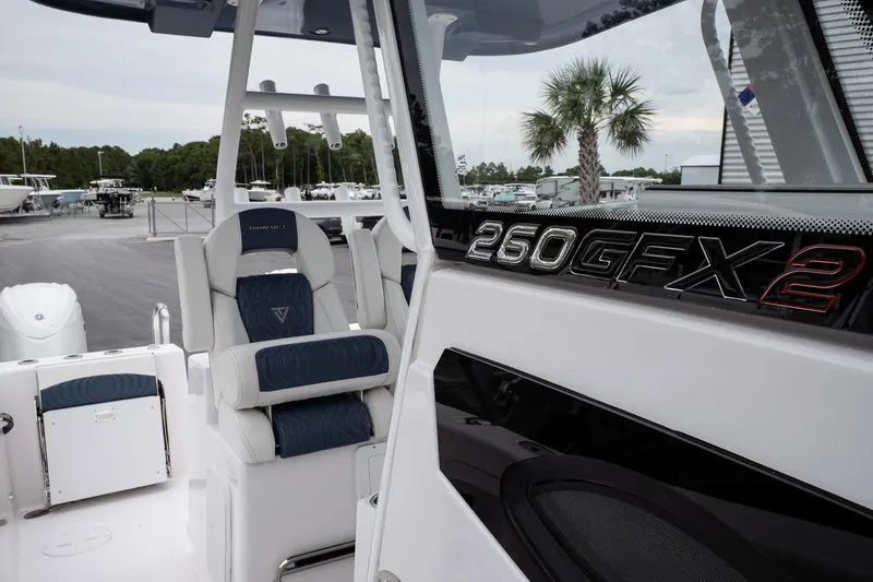 Slide: The Image of 2025 Twin Vee 260 GFX2 CC boat interior with seating and branding. - 25