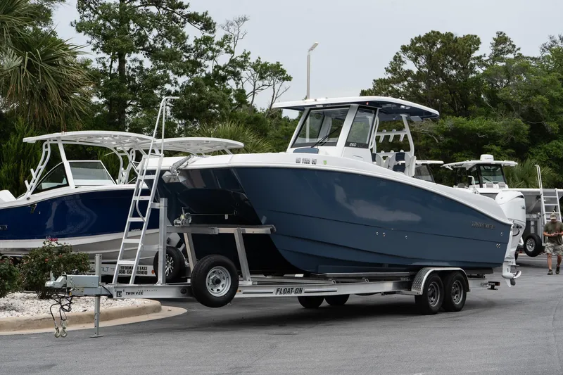 Slide: The Image of 2025 Twin Vee 260 GFX2 CC boat on trailer, parked outdoors. - 3