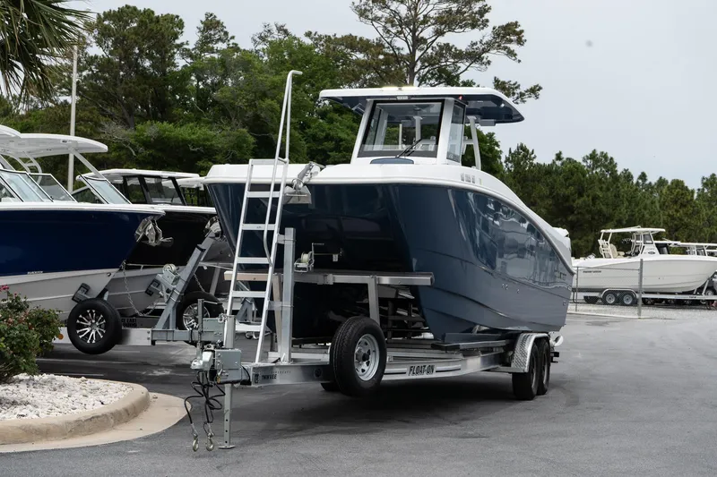 Slide: The Image of 2025 Twin Vee 260 GFX2 CC boat on trailer, parked outdoors. - 4