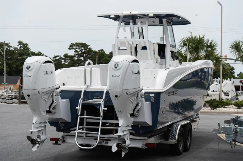 Slide: The Image of 2025 Twin Vee 260 GFX2 CC boat with dual engines on a trailer. - 8