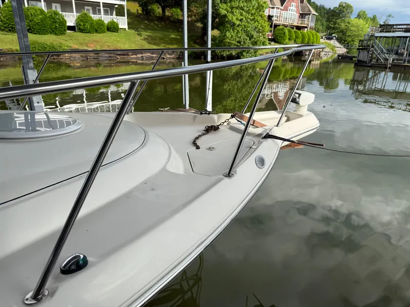 Slide: The Image of 2001 Monterey 322 Cruiser docked on a calm lake with scenic background. - 10