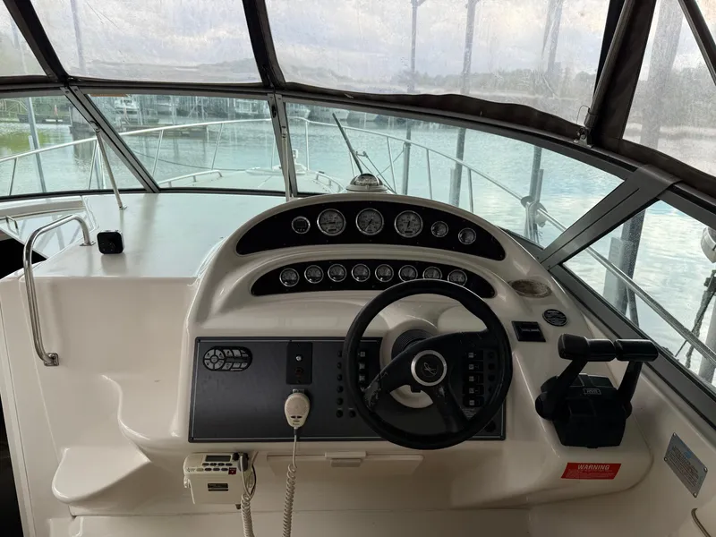 Slide: The Image of Cockpit view of a 2001 Monterey 322 Cruiser boat with steering wheel and control panel. - 12