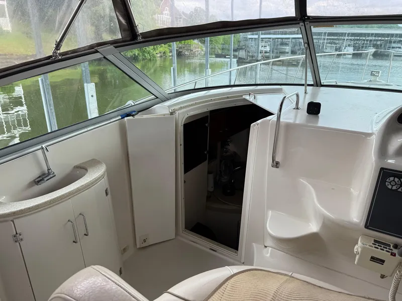 Slide: The Image of 2001 Monterey 322 Cruiser interior with helm, sink, and cabin entrance. - 13