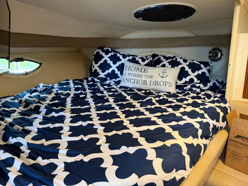 Slide: The Image of 2001 Monterey 322 Cruiser cabin with nautical bedding and decorative pillow. - 17