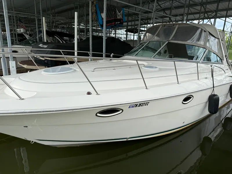 The Image of 2001 Monterey 322 Cruiser docked in a marina, featuring sleek white design. - 2