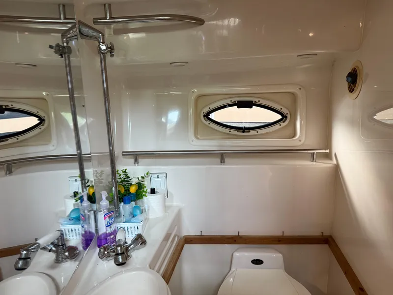 Slide: The Image of Bathroom interior of 2001 Monterey 322 Cruiser with mirror and porthole window. - 21