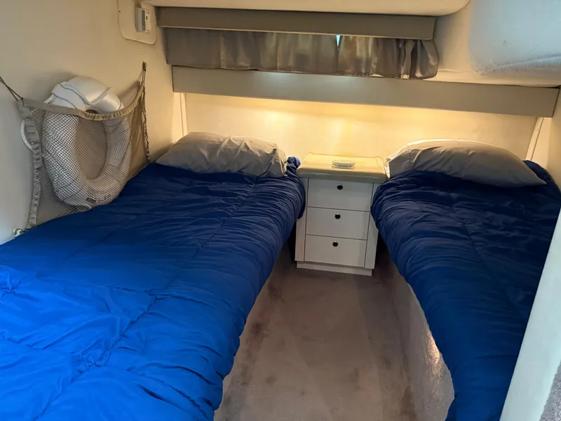 Slide: The Image of 2001 Monterey 322 Cruiser cabin with twin beds and blue bedding. - 22