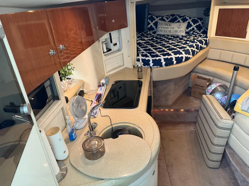 Slide: The Image of Interior of 2001 Monterey 322 Cruiser with kitchenette and cozy sleeping area. - 25