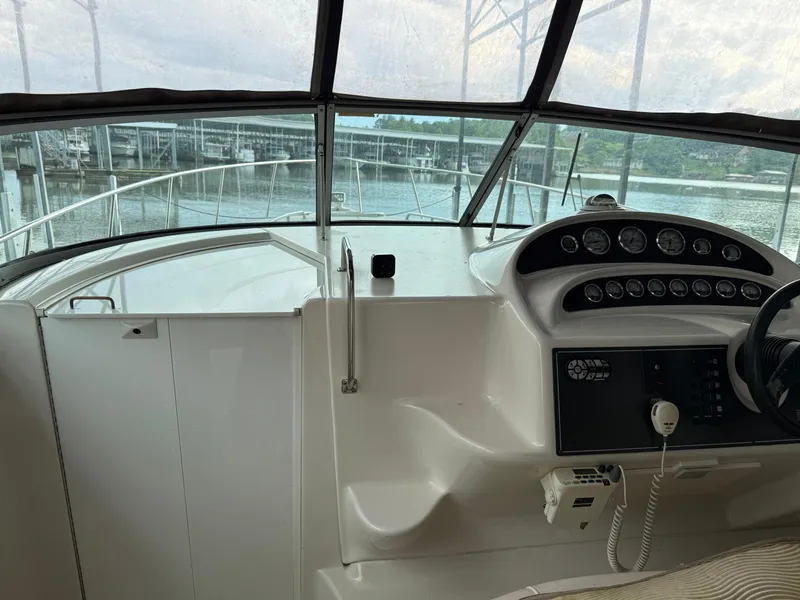 Slide: The Image of 2001 Monterey 322 Cruiser helm with gauges and steering wheel, docked by the water. - 26