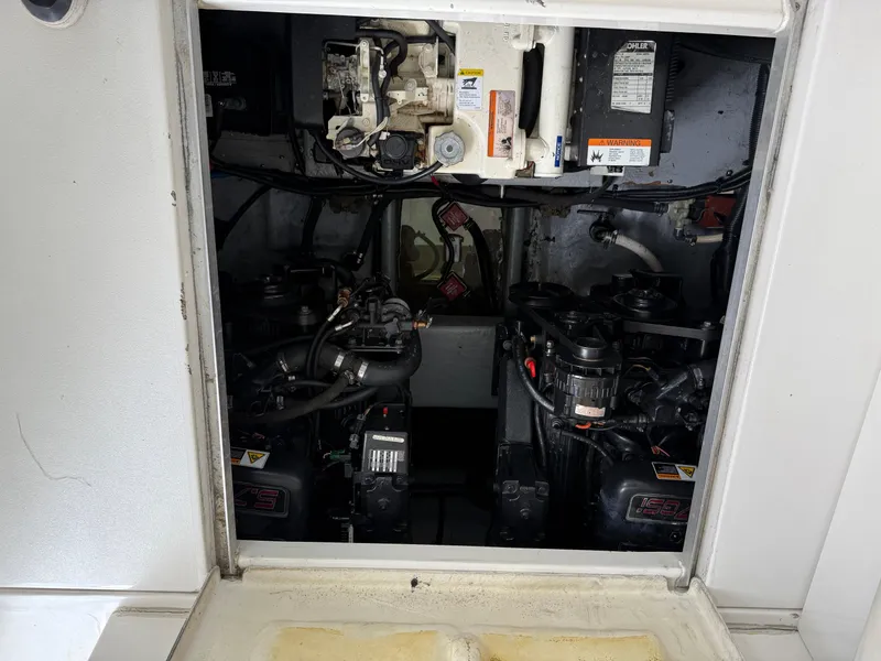 Slide: The Image of Engine compartment of a 2001 Monterey 322 Cruiser boat, showcasing dual engines and mechanical components. - 28