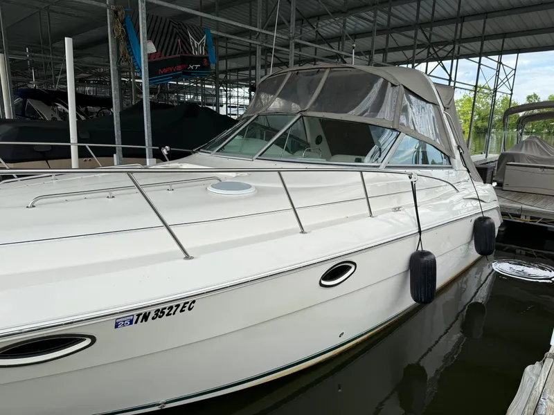 Slide: The Image of 2001 Monterey 322 Cruiser docked in a marina, featuring a sleek white exterior. - 3