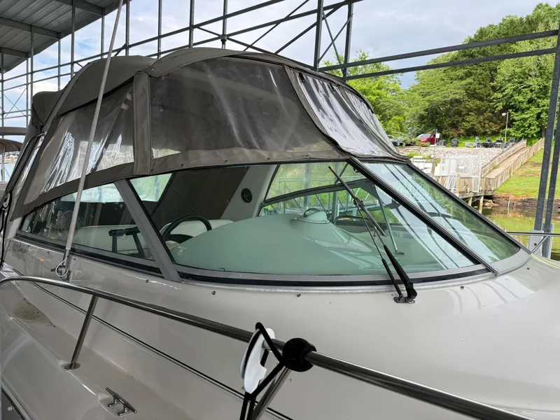 Slide: The Image of 2001 Monterey 322 Cruiser boat docked under a metal canopy. - 8