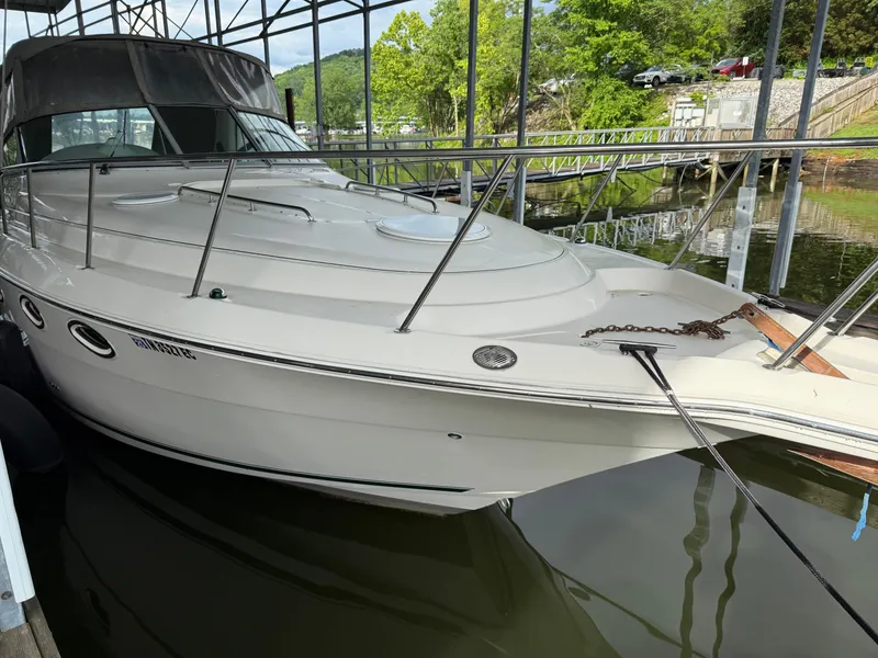 Slide: The Image of 2001 Monterey 322 Cruiser docked in a marina, featuring sleek design and white exterior. - 9