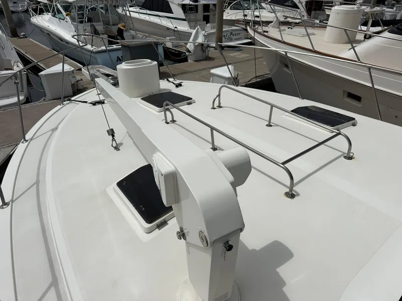 Slide: The Image of 1978 Bertram 46 Convertible yacht deck with railing and hatches at marina. - 11