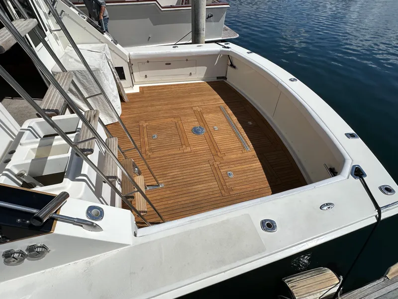 Slide: The Image of 1978 Bertram 46 Convertible yacht with teak deck, docked at marina. - 13