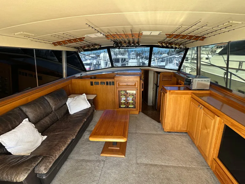 Slide: The Image of Interior of a 1978 Bertram 46 Convertible yacht with wood furnishings and fishing rods. - 16
